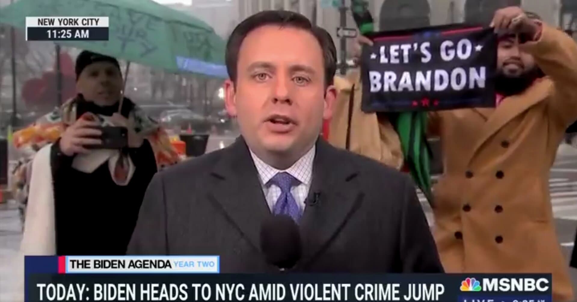 Watch: Man Waves ‘Let’s Go Brandon’ Flag in Background of MSNBC Live Shot in NYC