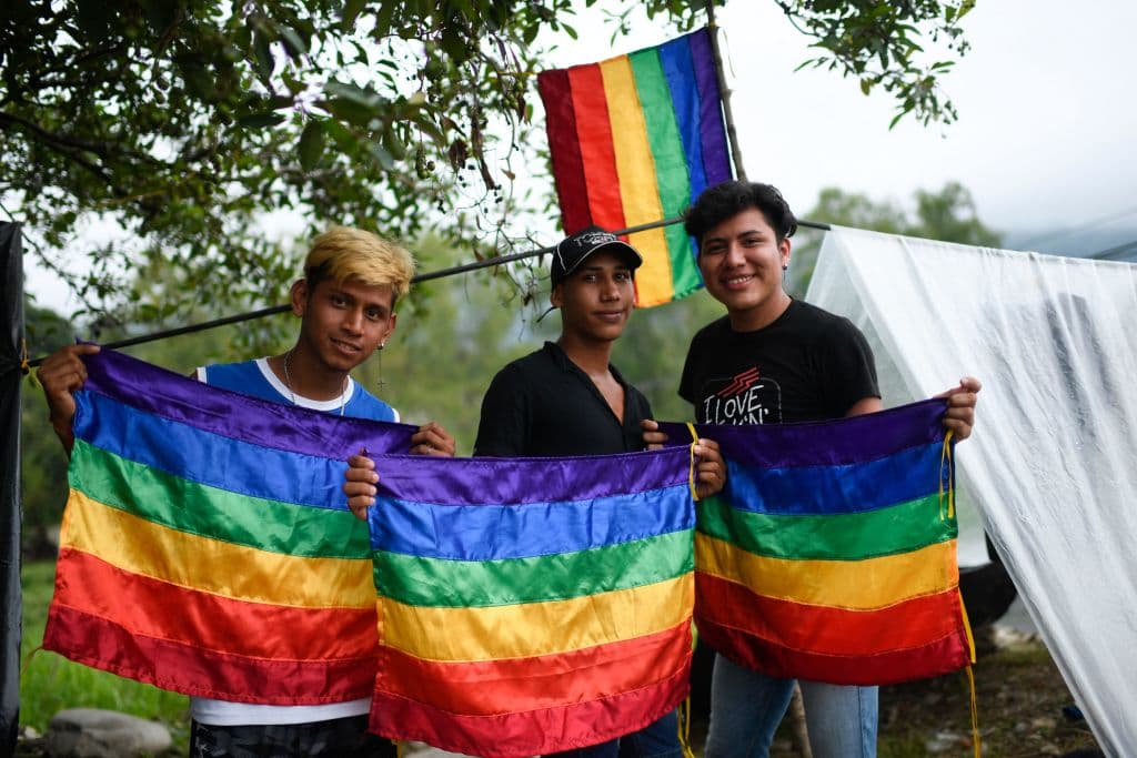 Massive Migrant Caravan Marches Toward US with LGBT Flags Flying as Mexican President Snubs Biden at Summit