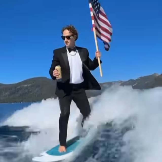 Zuckerberg Wakesurfs in Tuxedo While Holding Flag, Drinking Beer — Sparks Reaction
