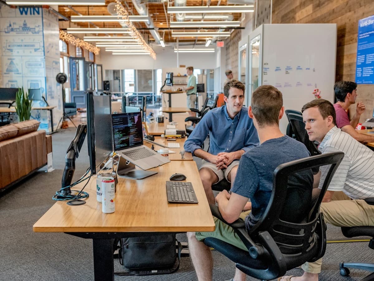 Consultants talking through a project in an open office