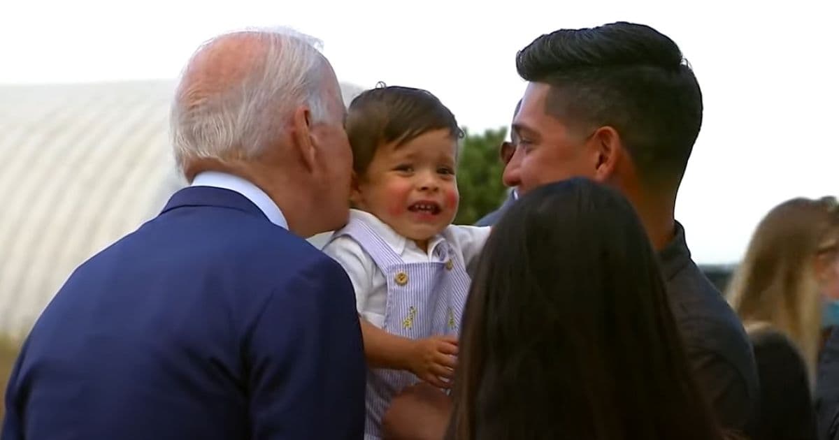 Biden Defies COVID Protocol, Appears To Scare Baby When He Leans In for Kiss
