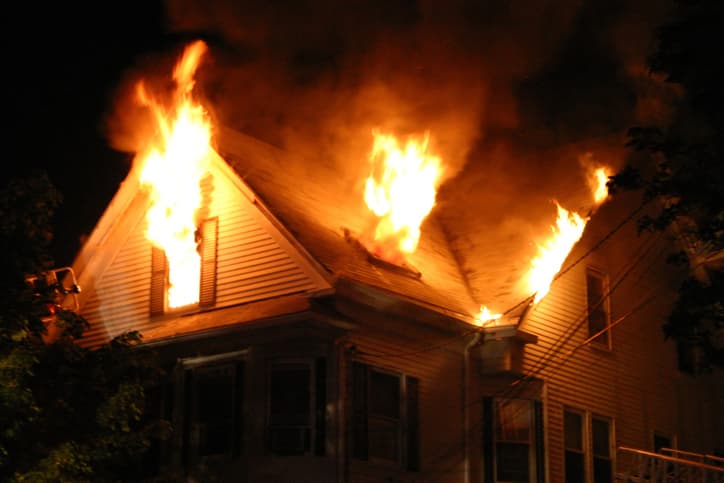 Man Shot by Police Inside Burning Home After Woman Found Dead, Others Rescued