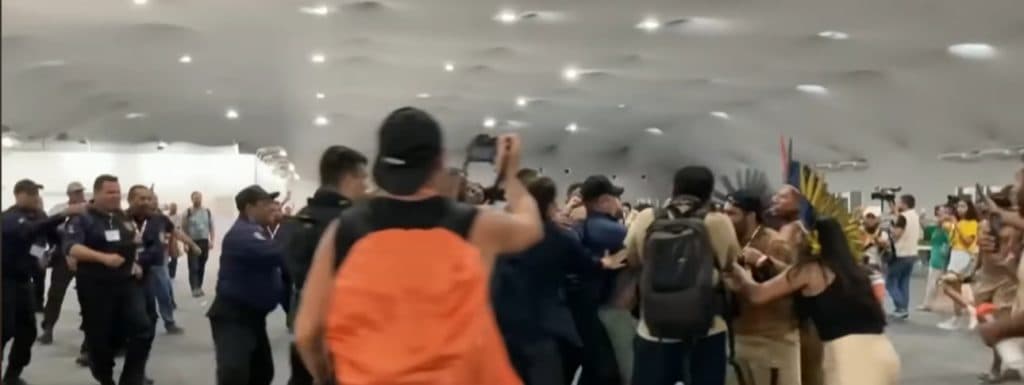Feather-Headed Protesters Storm Elite Climate Summit In Chaotic Scene