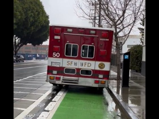 An ambulance sits in the bike lane in San Francisco.