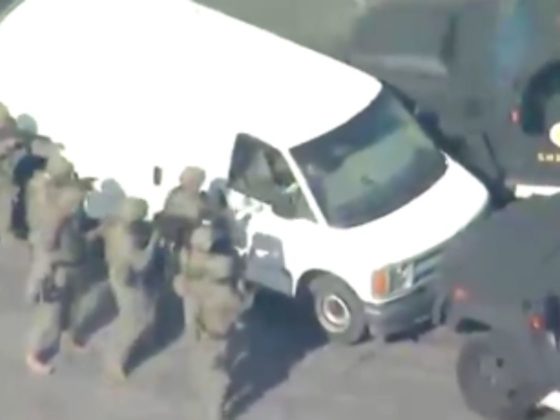 Law enforcement enter a white van after the Lunar New Year shooting in Monterey Park, California.