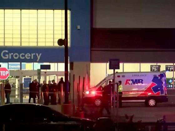 Police and medical personnel are pictured outside a Walmart in Evansville, Indiana, late Thursday after a shooting.