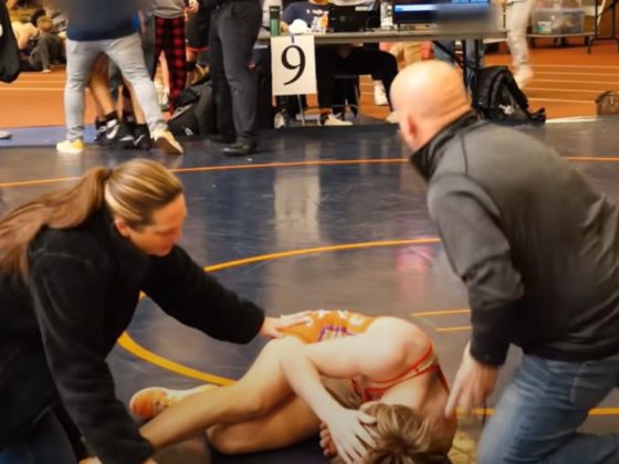 Adults attend to Cooper Corder after the 14-year-old was sucker punched after winning an April 8 match in Illinois.