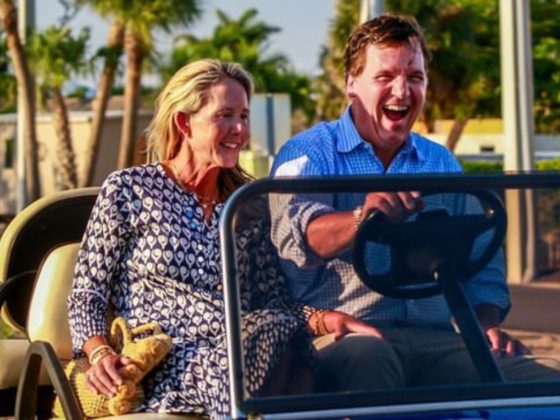 Tucker Carlson and his wife, Susan, ride in a golf cart near his Florida home.