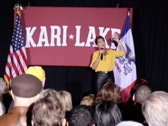 Kari Lake, the Republican who's still challenging the results of Arizona's flawed election for governor in November, is pictured speaking on stage April 7 at the University Iowa in Des Moines.