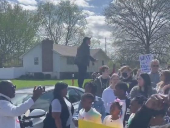 Protesters are seen in Kansas City, Missouri, on Sunday after a 16-year-old was shot.