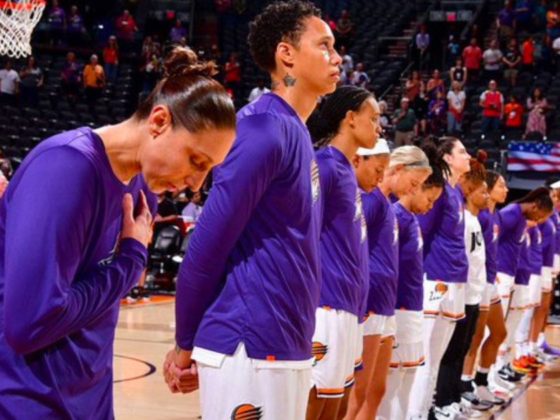 Brittney Griner of the Phoenix Mercury, center, stands for the national anthem before a preseason game against the Los Angeles Sparks in Phoenix on Friday.
