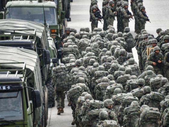 Troops assigned to a brigade under the Chinese People's Liberation Army 73rd Group muster in emergency to set out for the designated real-combat training field on Nov. 21, 2022.