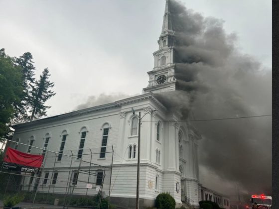 Smoke pours out of the historic First Congregational Church in Spencer, Massachusetts, Friday.