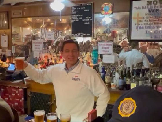 Florida Gov. Ron DeSantis serves beer to patrons at "The Bunker" VFW Post 9211 before the Reno Rodeo in Nevada on Friday.