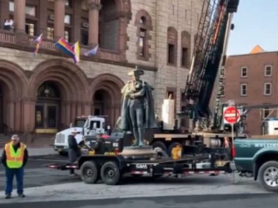 A work crew removes a statue of Revolutionary War Gen. Philip Schuyler from the front of city hall in Albany, New York, on Saturday.