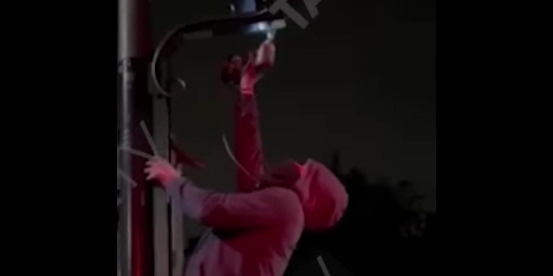 Someone is seen removing an Ultra Low Emission Zone camera.