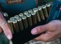 A man holds Hornady ammo.