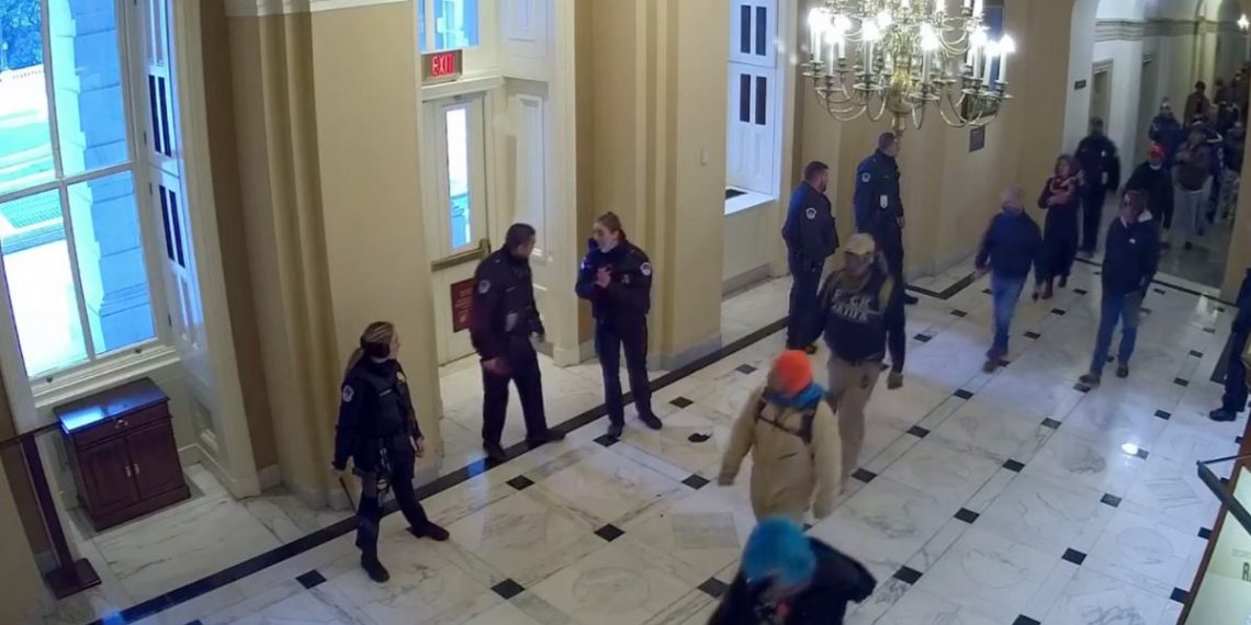 Video released Friday from Jan. 6, 2021, shows protesters strolling calmly down the hallway with some Capitol Police officers appear to casually look on.