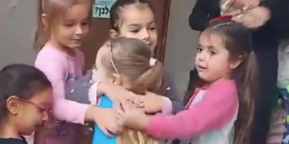 Emilia Aloni, center, was greeted with hugs from her kindergarten classmates on her first day back in class after being held captive by Hamas terrorists for seven weeks.