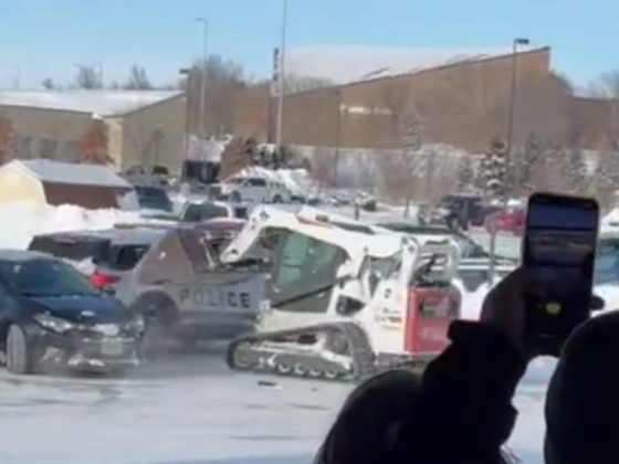 Witnesses shot videos with their cell phones as the Bobcat scooted around the snowy parking lot and rammed a police cruiser.