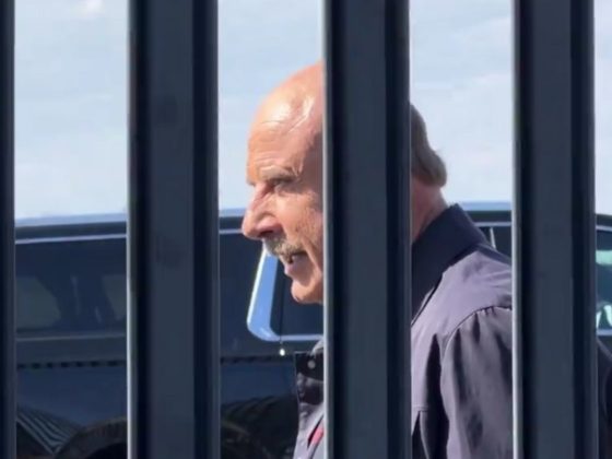Dr. Phil reading a statement at the border
