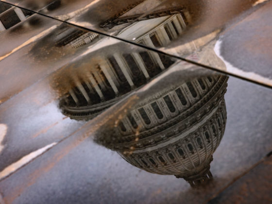WASHINGTON, DC - FEBRUARY 11: The U.S. Capitol building is seen reflected in rain puddles on February 11, 2024 in Washington, DC. The Senate is convening for a rare Sunday session to vote on a supplementary spending bill that includes military aid for Ukraine, Israel, and Taiwan without addressing border security after Republicans in the House abandoned an agreement that they initially agreed to. (Photo by Samuel Corum/Getty Images)