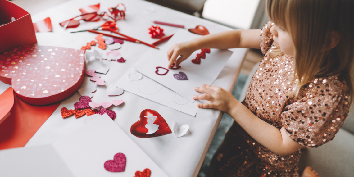 Toddler making greeting card for mom and dad at home