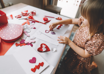 Toddler making greeting card for mom and dad at home