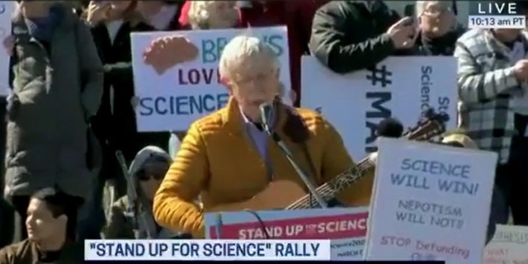 At Anti-Trump Rally, Former NIH Director Sings The Same Way He Practices Science