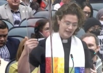 Rainbow-Clad Female Reverend Compares ICE Supporters To Judas