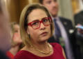 Men Shout Affair Claims at Kyrsten Sinema Panel as Ex-Bodyguard’s Wife Alleges Romance