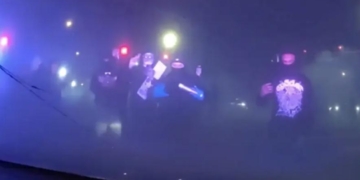 Masked Individuals Surround Patrol Car With Police Inside