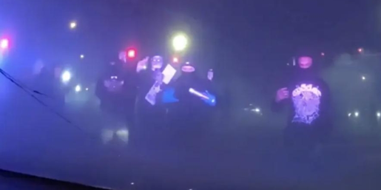 Masked Individuals Surround Patrol Car With Police Inside