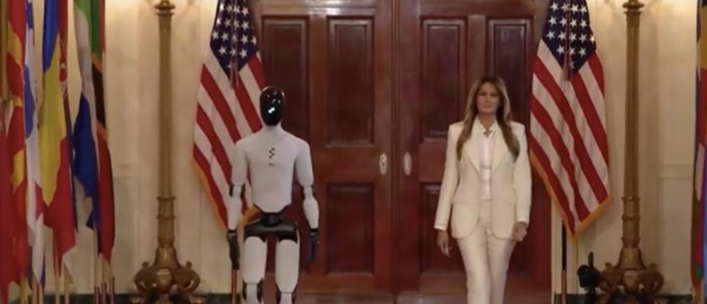 Watch Surreal Scene As Robot That Walks Like Joe Biden Disappears Behind Melania